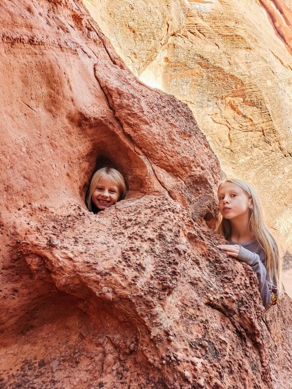 girls standing on rocks