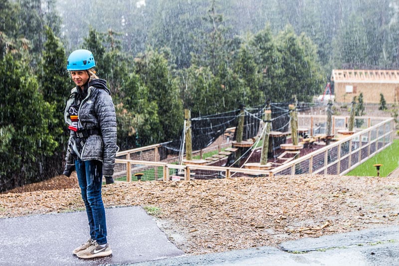 girl standing in rain at obstacle course
