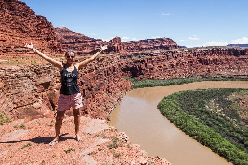 woman standing next to a canyon