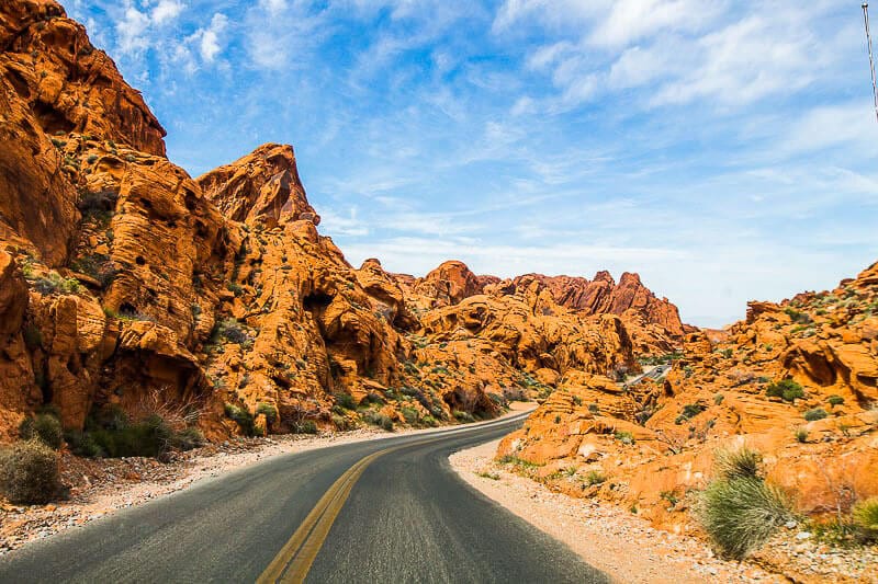 road running past red rocks in valley of fire