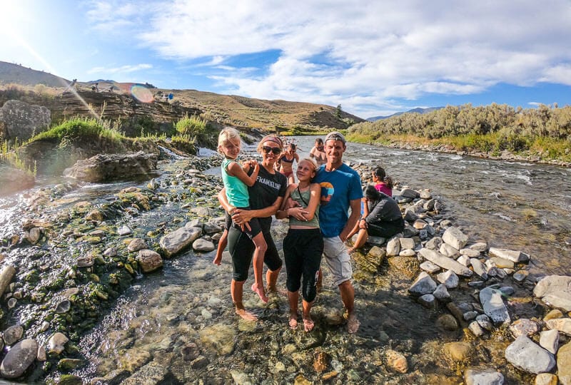 family standing in boiling river, yellowstone