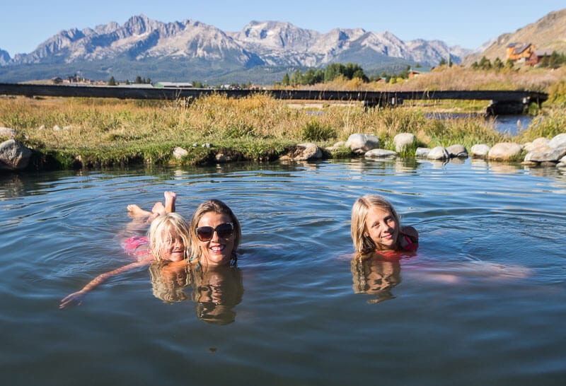 people swimming in a hot spring