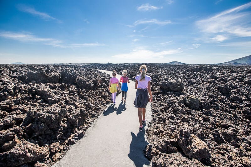youjng girls walking on trail through the lava fields at Craters of the Moon National Park