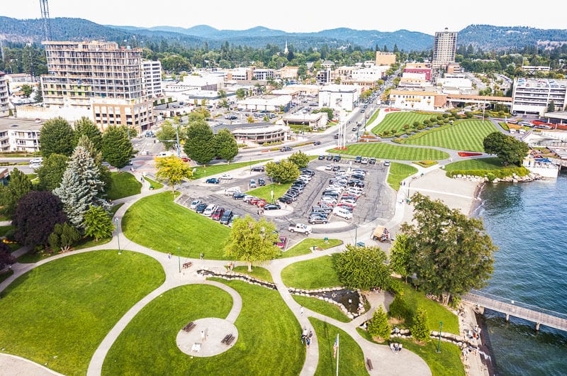 aerial view of green parks, Coeur d’Alene, city and mountains