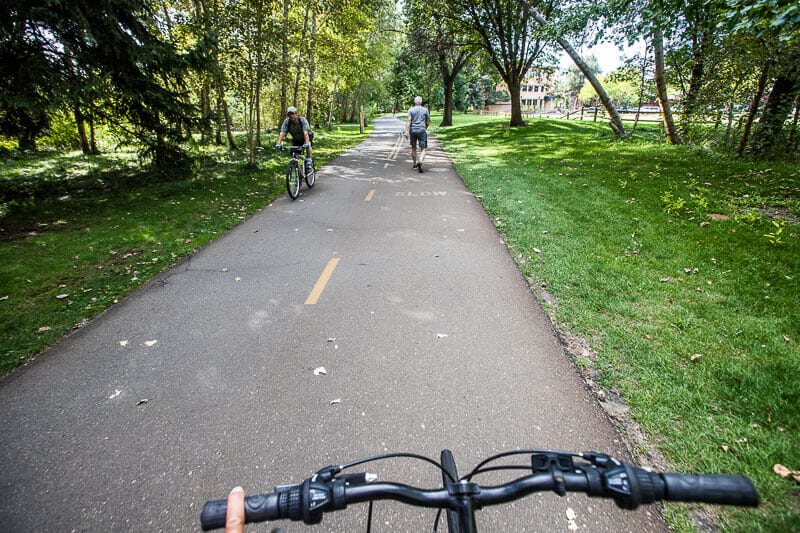 people bike riding through a park