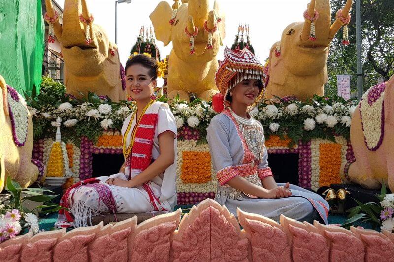 thai women in traditional dress on Chiang Mai Flower festival float