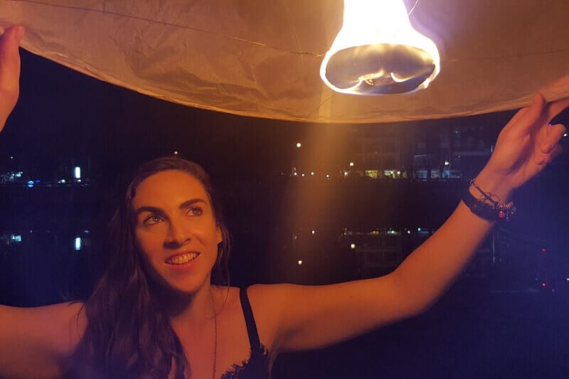 person releasing a Khom Loy lantern
