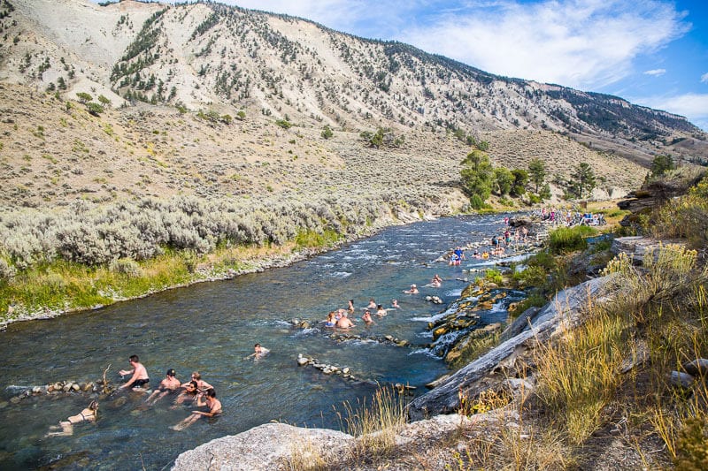 people sitting in the Boiling River in Yellowstone National Park