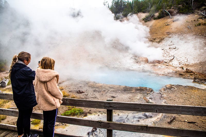 girl looking at a geyser