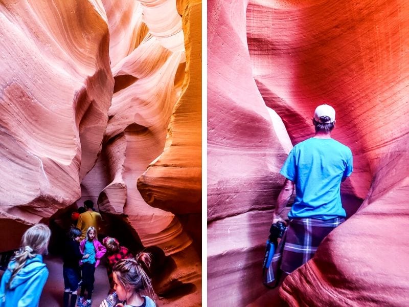 people walking past curved rock walls in Lower Antelope Canyona