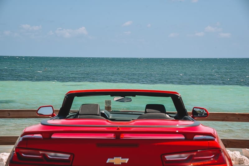 A car parked next to the ocean