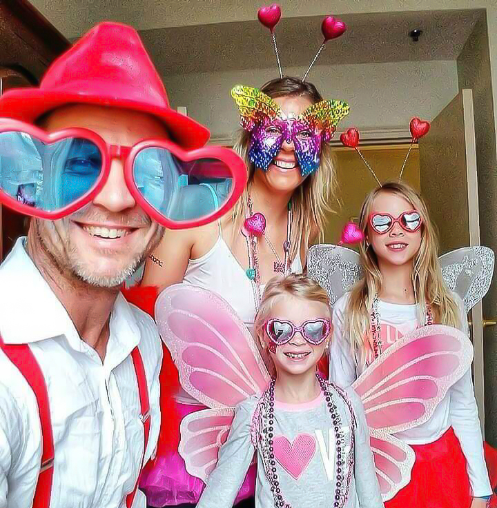 family wearing butterfly outfits and masks