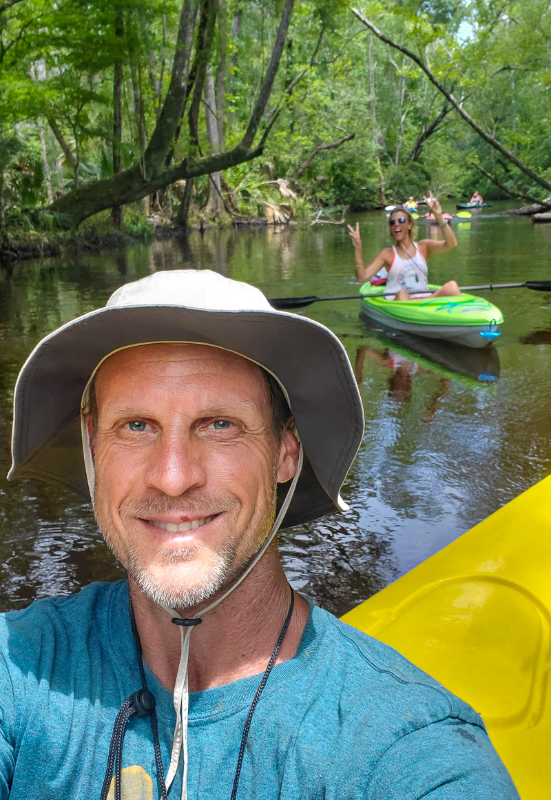 man in a hat kayaking
