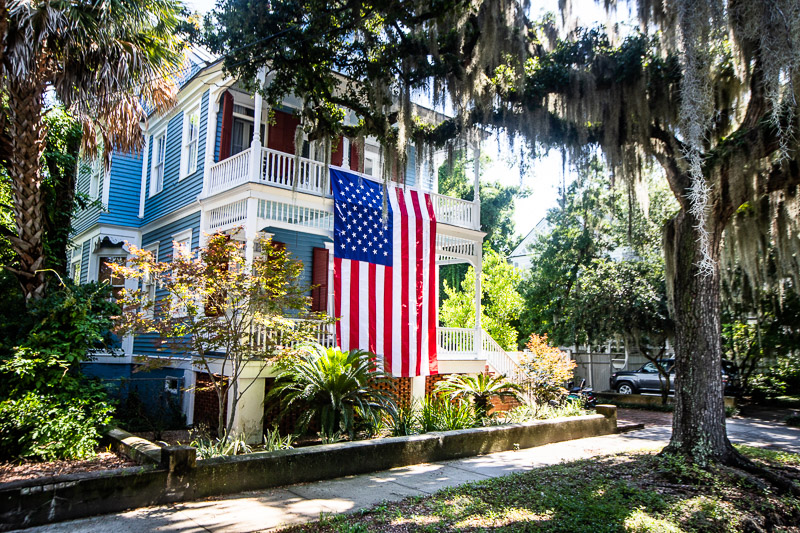 historic blue house with flag draping over it
