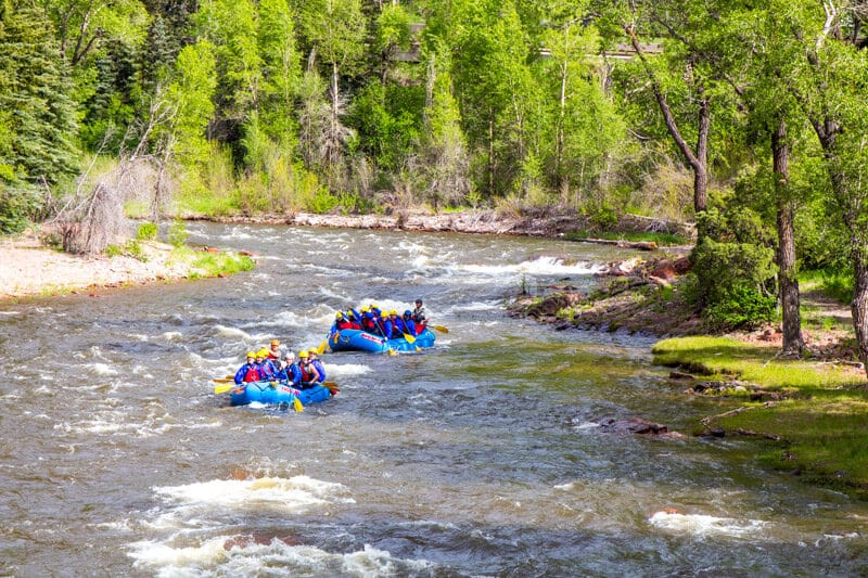 people on boats in river rapids