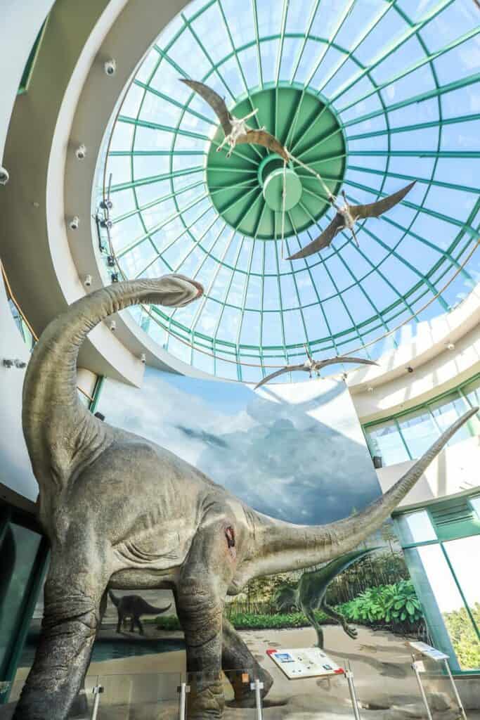 dinosaur in exhibit under domed glass ceiling