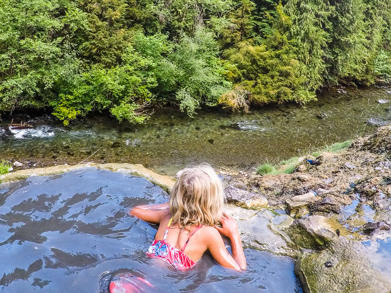 a little girl in a hot spring