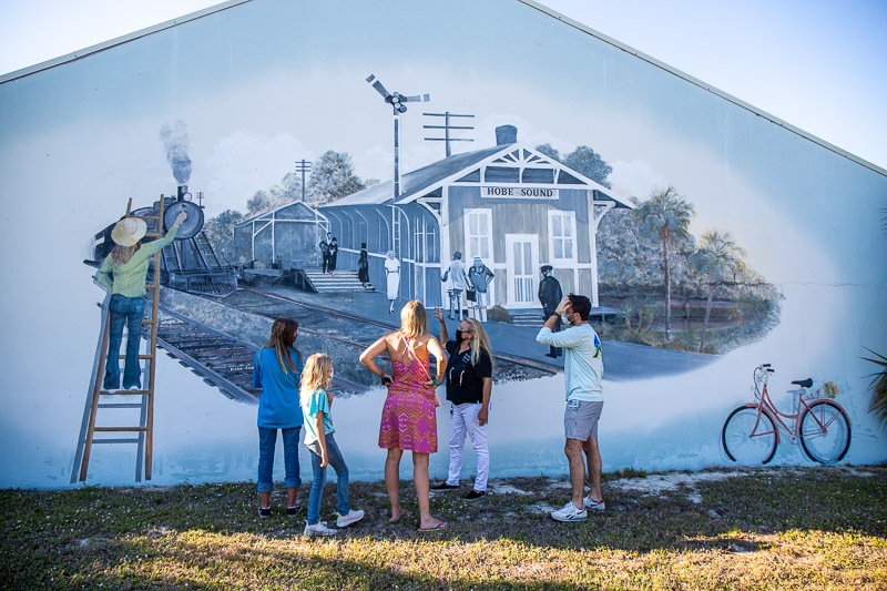 people looking at mural With Nadia from Hobe Sound Mural Tours