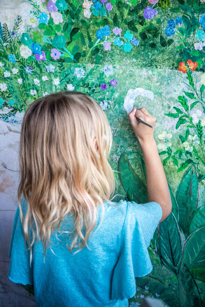 girl painting on a wall