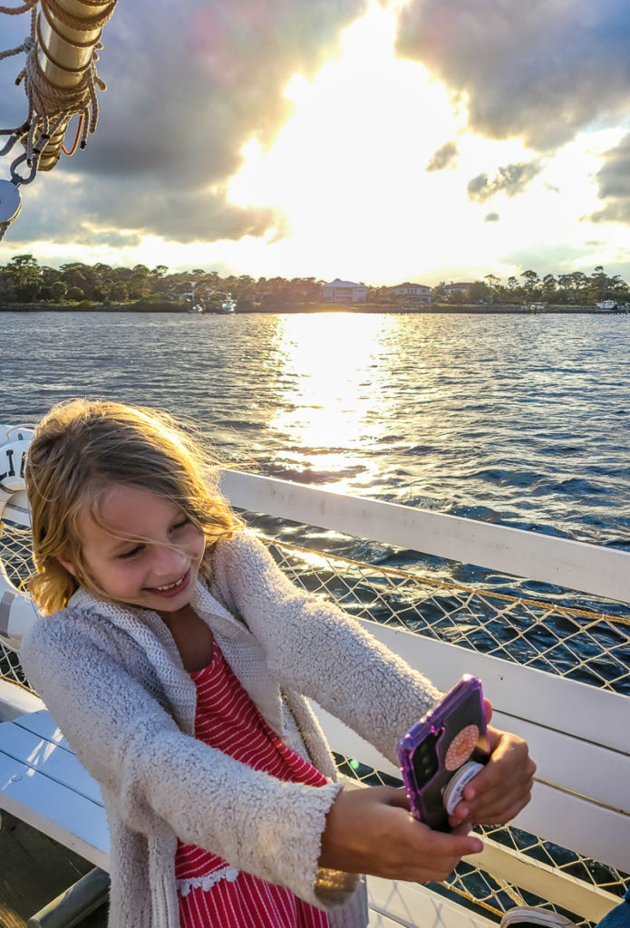 girl taking selfies on a boat