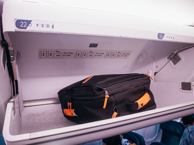backpack in plane overhead bin