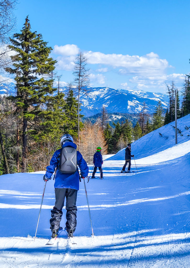 family skiing down silver mountain resort ski idaho