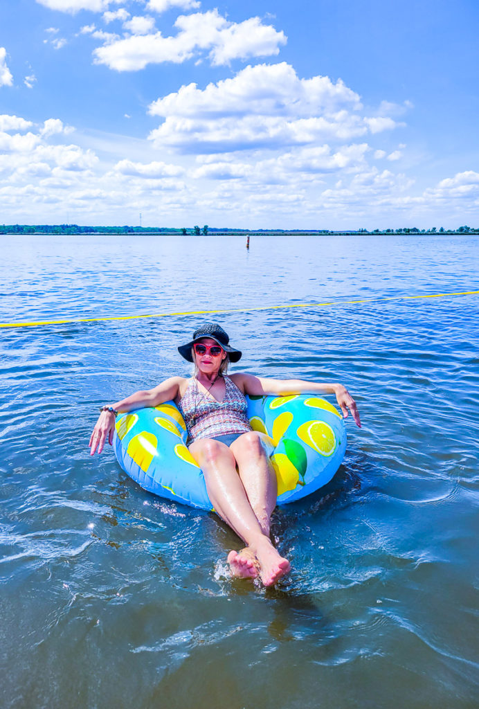woman sitting on a pool inflatable