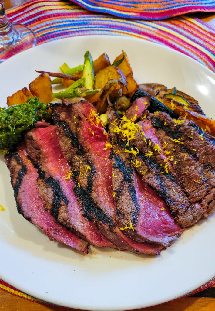 sliced sirloin with vegetables on plate