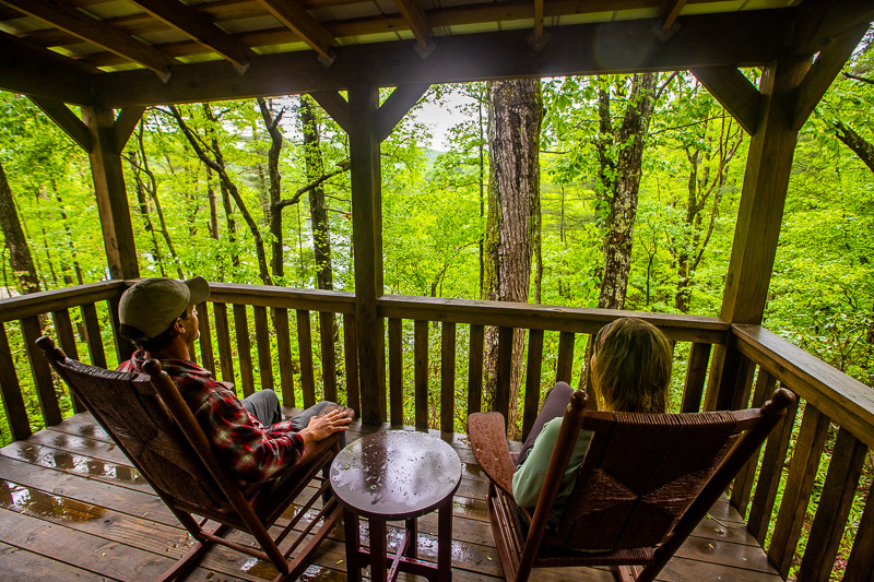 people sitting in rocking chairs on deck unicoi state park cabins