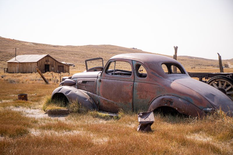 old rusted car in field