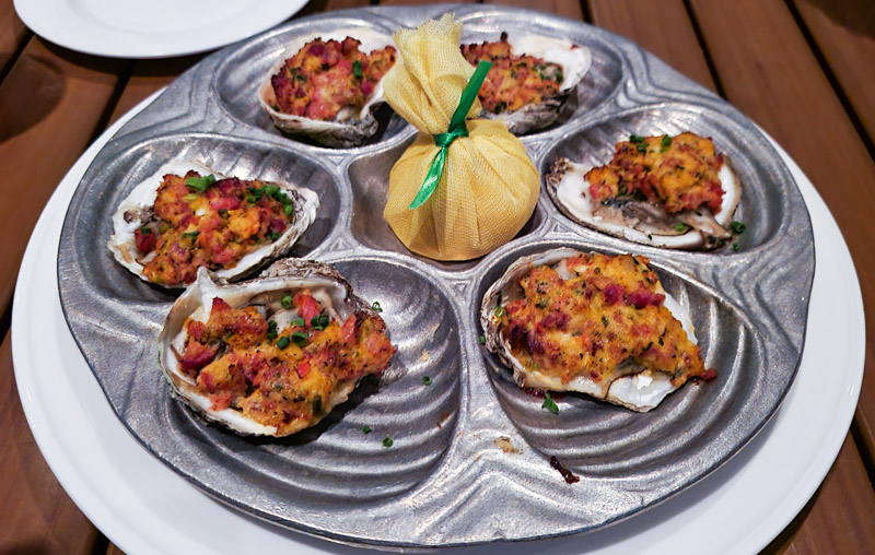 plate of oysters topped with bacon
