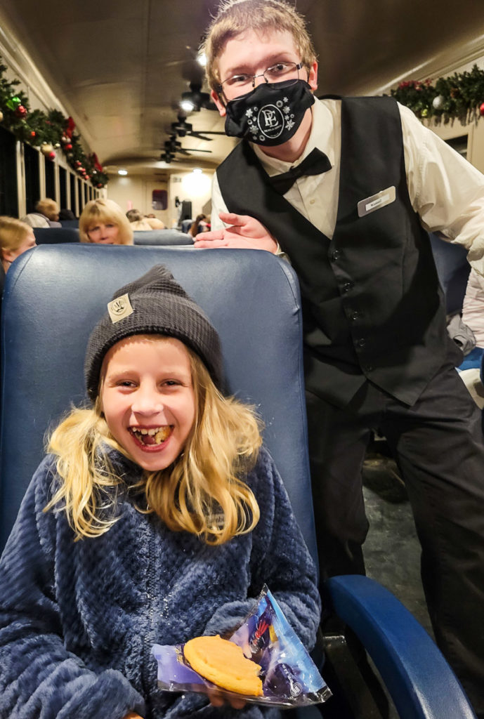 girl laughing with a conductor on The Polar Express train ride