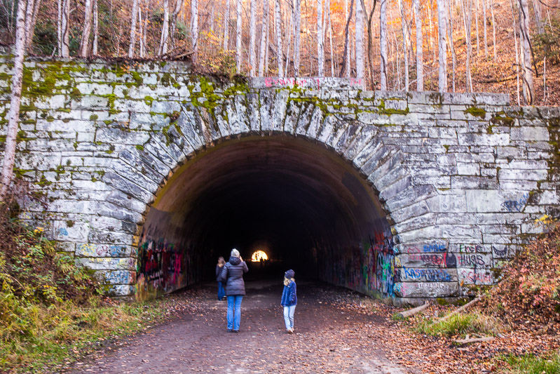 people walking into a tunnel