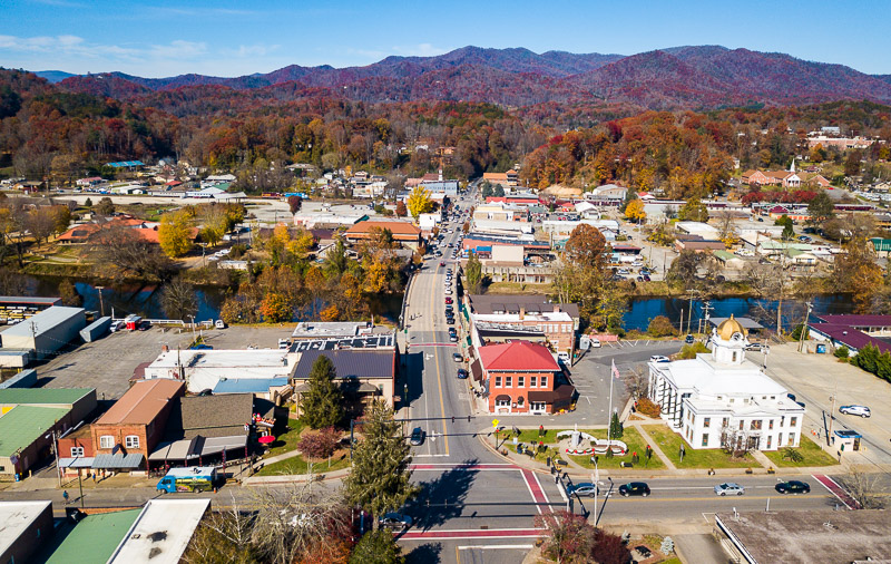 aerial view of Downtown Bryson City, NC with mountains covered in fall foliage