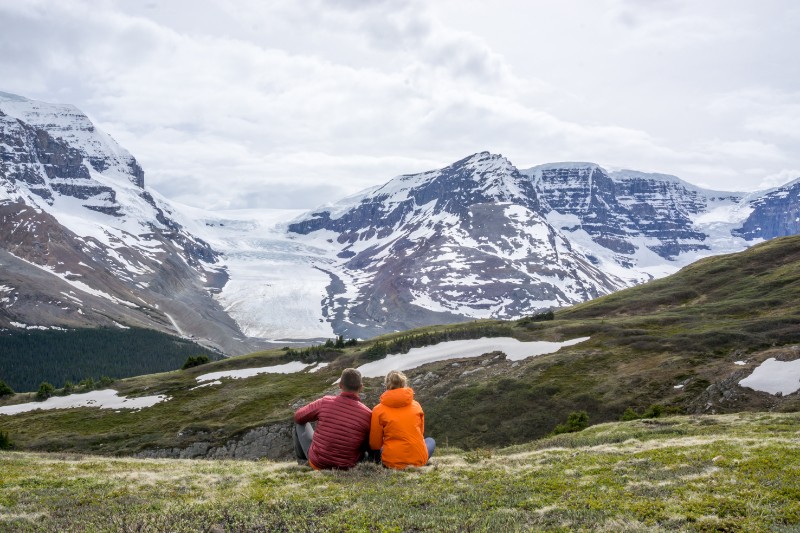 Two people sitting looking at the view of Athabasca Glacier from Wilcox Pass Hike, Jasper National Park