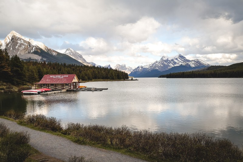 photo of Maligne Lake with red roofed boat shed and mountain backdrop, Jasper National Park