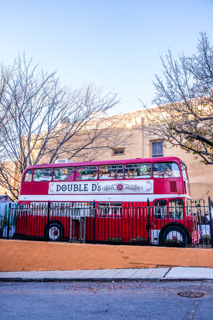 A double decker bus parked on the side of a building