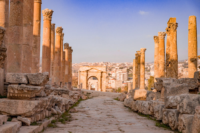 stone cobbled road with columns on either site Colonnaded street Jerash