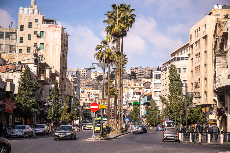 streets with buildings on the side of the road and palm trees