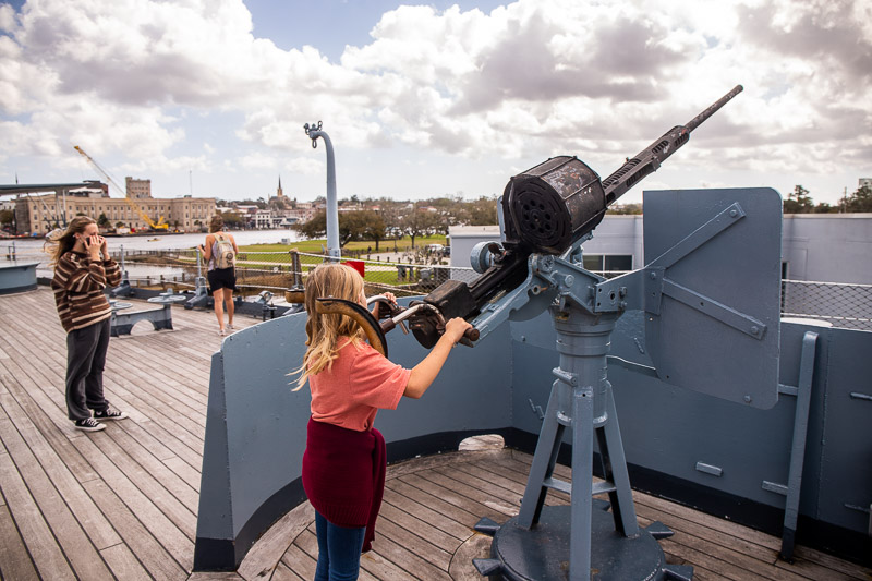 girl standing on an old battleship