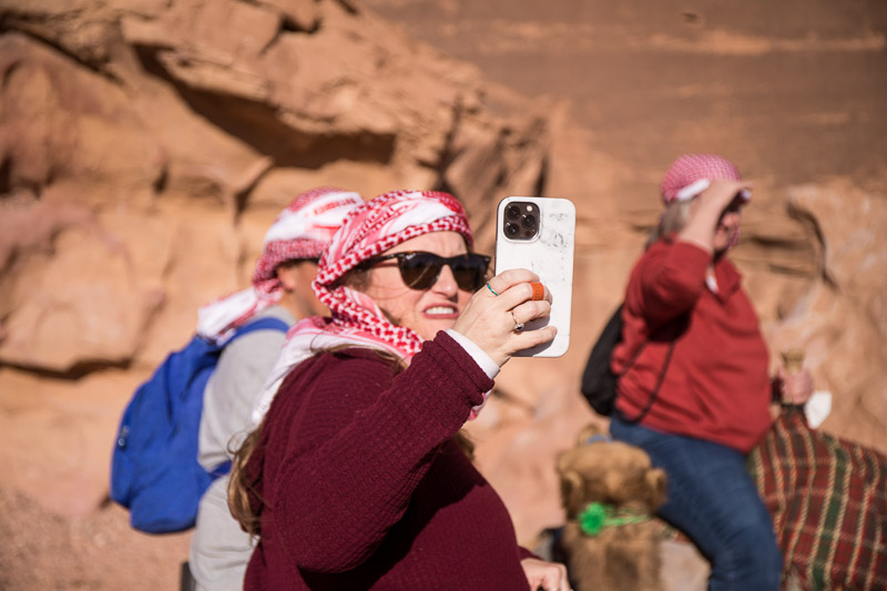 woman taking a selfie while wearing a head scarf