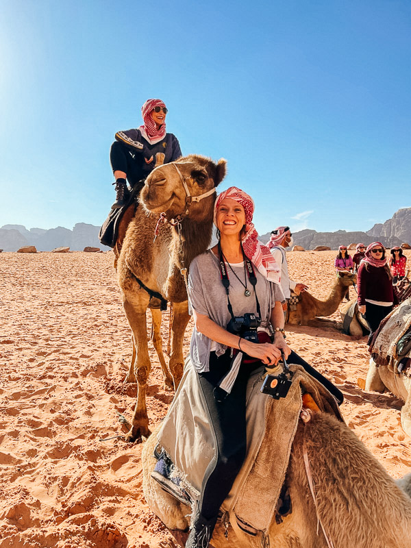 two women on a camel in the Jordan desert