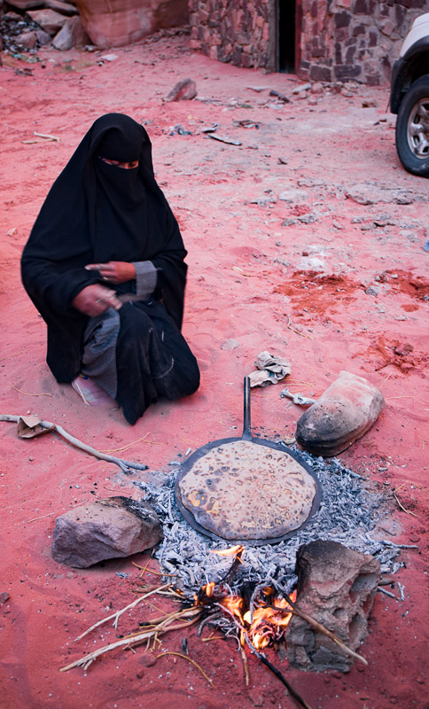 Jordanian family cooking bread over open fire