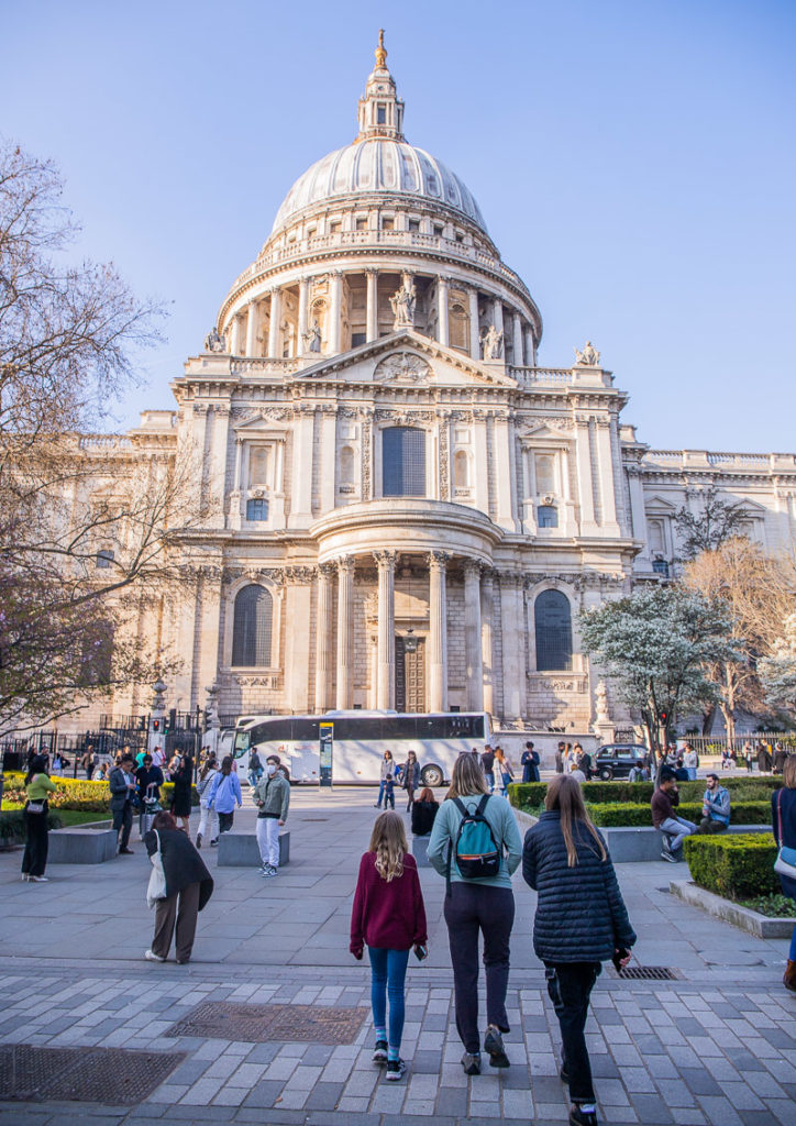 people looking astatine  at the dome of St Paul's Cathedral, London, England