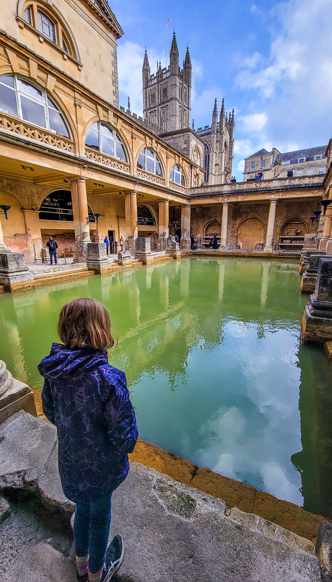 girl standing in front of the roman baths