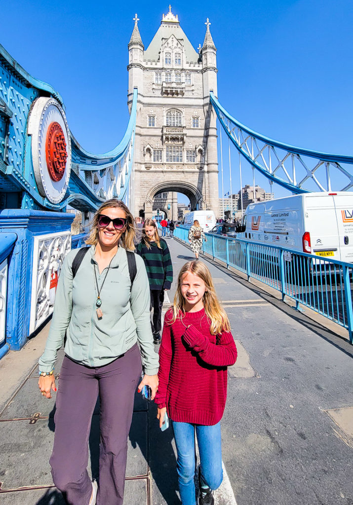 woman and girl walking across london bridge