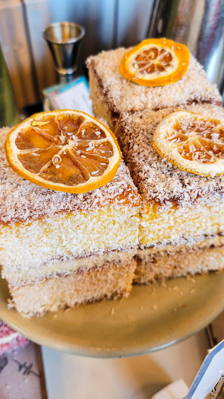 cream filled lamingtons with dried orangish  connected  top
