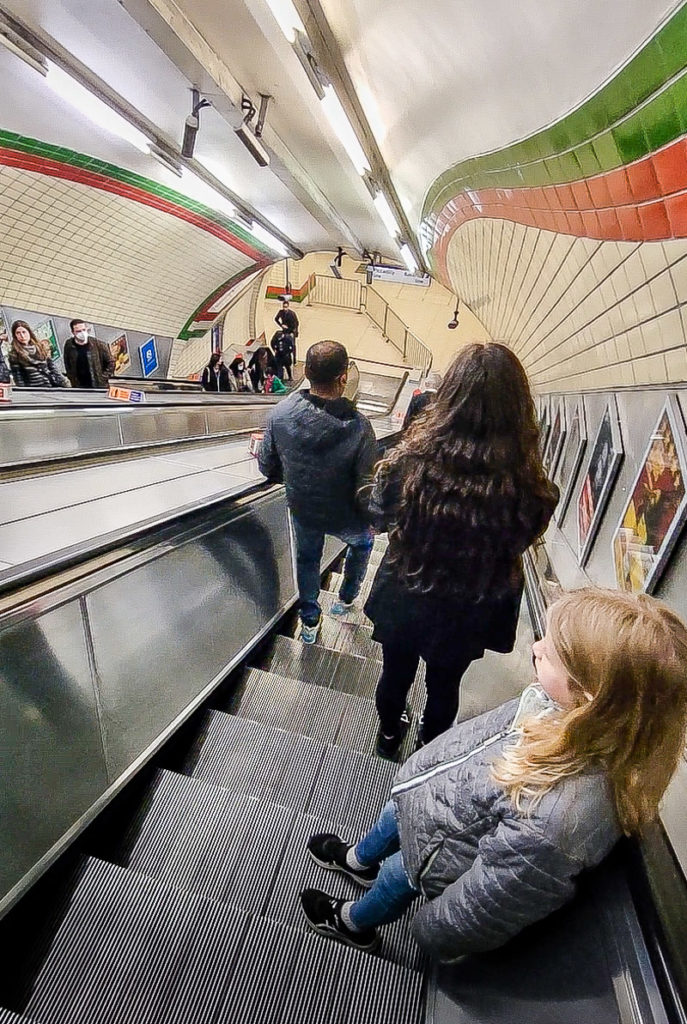 people standing on an escalator