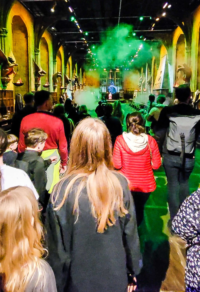 crowd of people standing in a movie set with green lighting