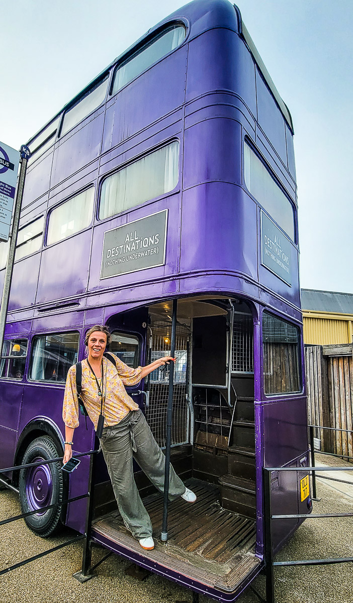woman standing in front of a purple bus